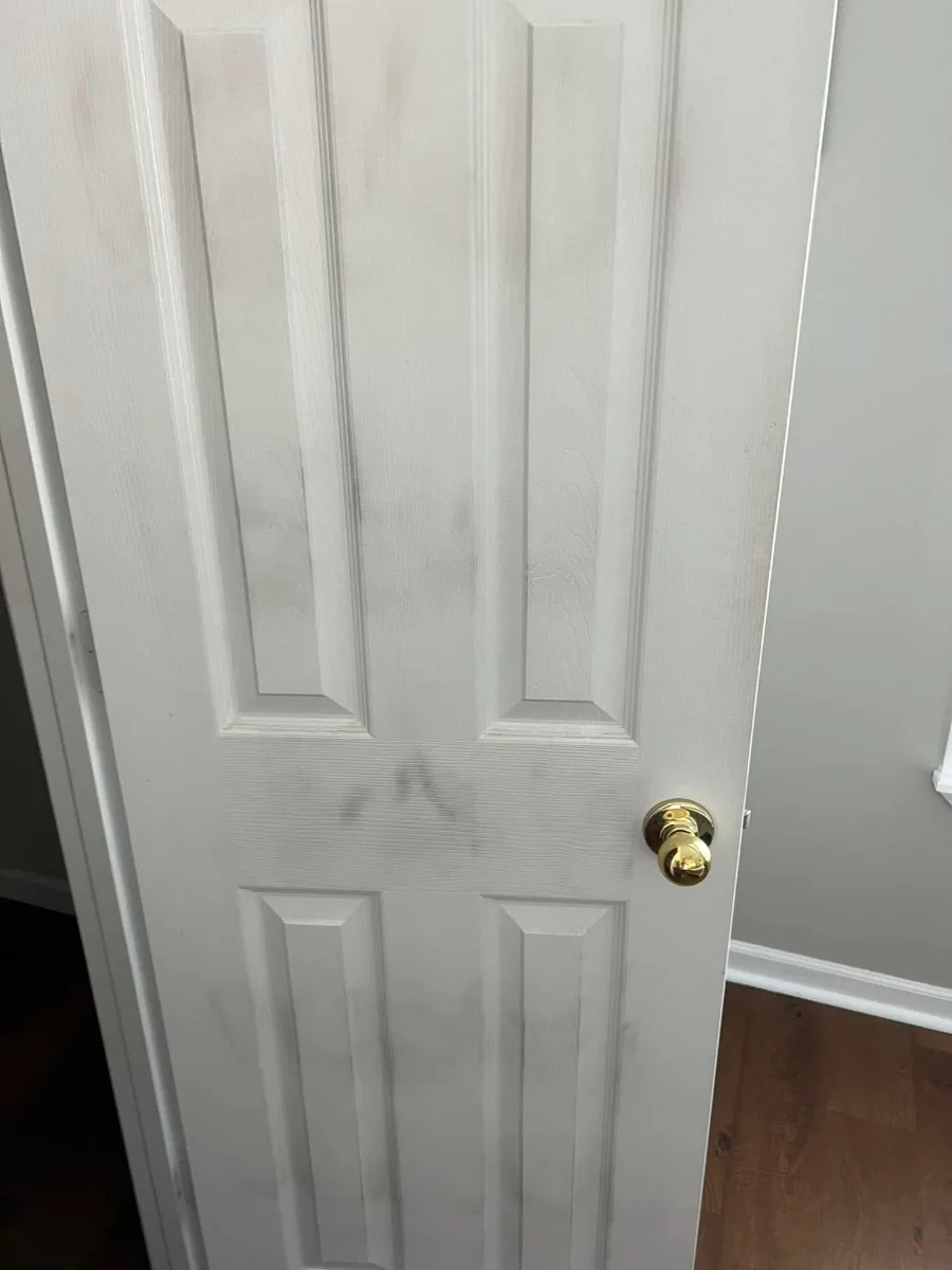 Before: a door covered in grime and handprints