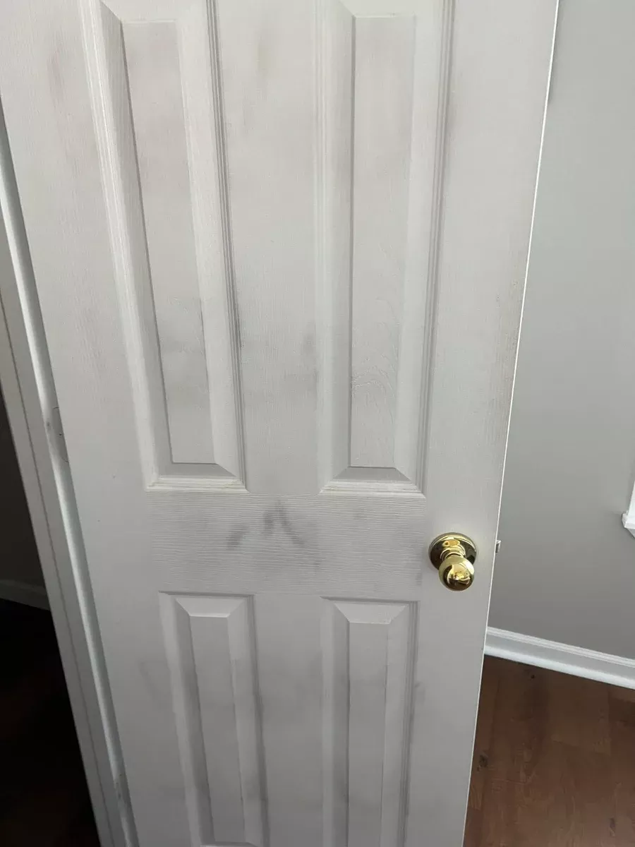 Before: a door covered in grime and handprints